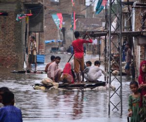 Residents use a raft to move along a waterlogged street in a residential area after a heavy monsoon rainfall in Hyderabad City on August 19, 2022. (Photo by Akram SHAHID / AFP) (Photo by AKRAM SHAHID/AFP via Getty Images)